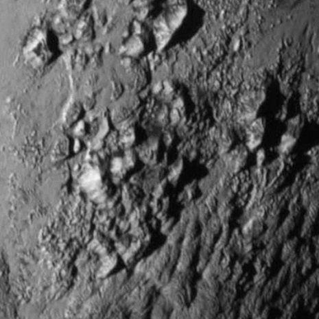 New Horizons -luotaimen lähettämässä ensimmäisessä lähikuvassa näkyy vuoristoista aluetta. Kuva: <span class="photographer">NASA.</span>